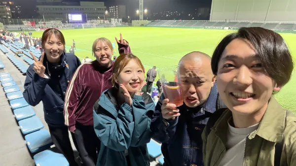 スタジアムで観戦する人々の集合写真